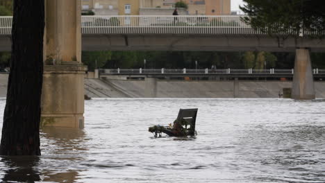 Public-bench-in-a-flooded-river-le-Lez-Montpellier-Antigone-France-heavy-rain